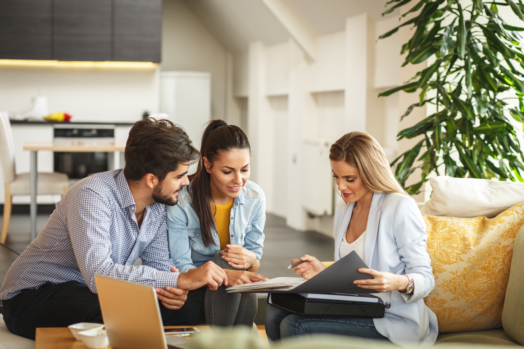 estate agent talking to young couple