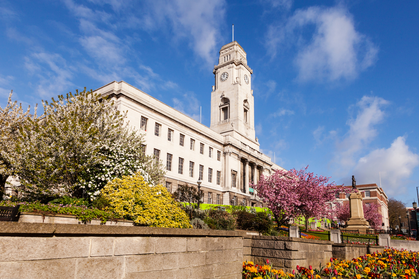 Barnsley Town Hall on a fine spring day, with blue sky and gardens in bloom.